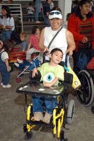 Woman pushing child with disabilities in wheelchair