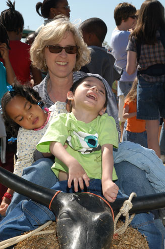 Mother with two children with disabilities sitting on a bull statue